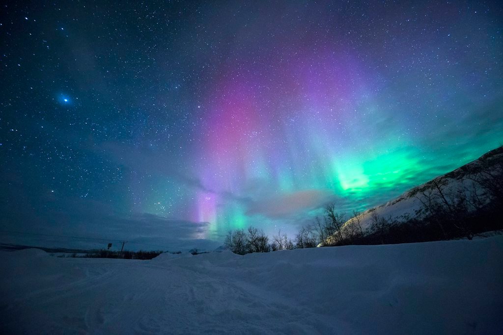 Vibrant geomagnetic storm auroral display lighting up the night sky during high solar activity