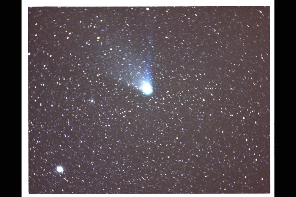Halley's Comet with its glowing tail against a field of stars, photographed during its 1986 visit
