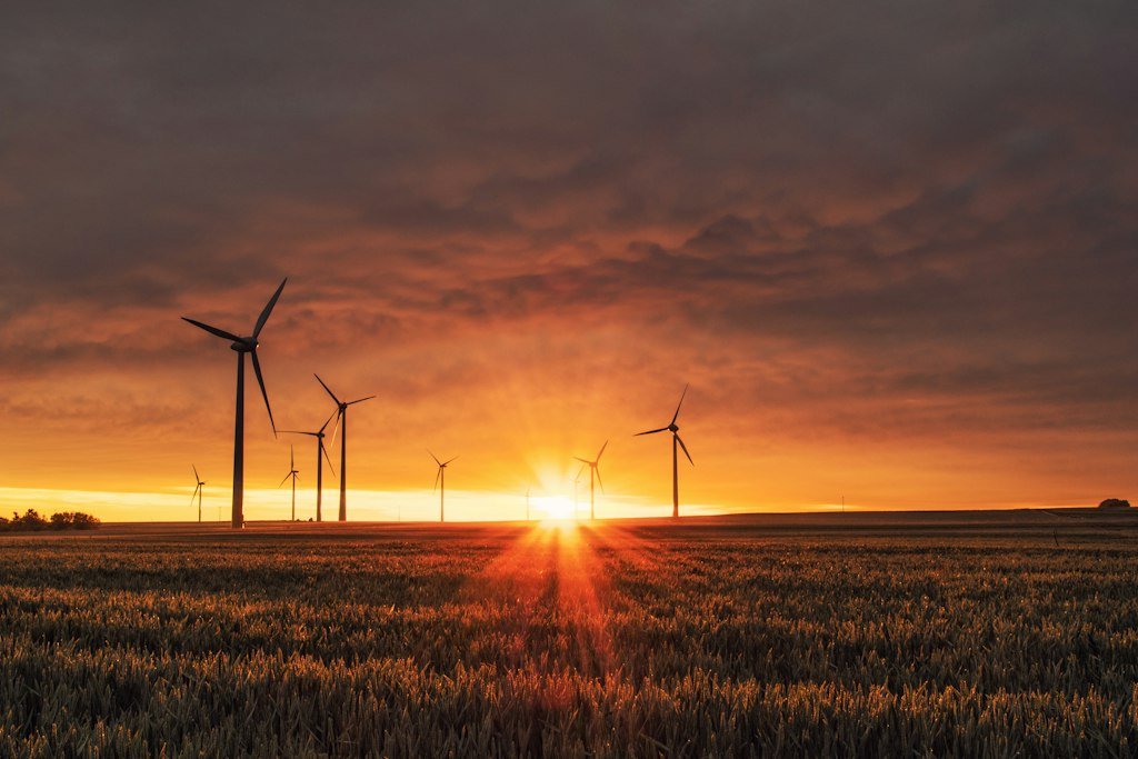 Clean renewable wind energy turbines generating carbon-free electricity for 2030 emissions goals