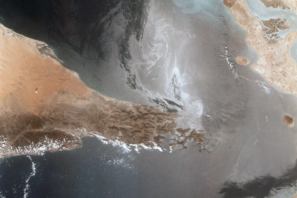 The Strait of Hormuz seen from space, the narrow channel between Iran and the Arabian Peninsula that carries much of the world's oil