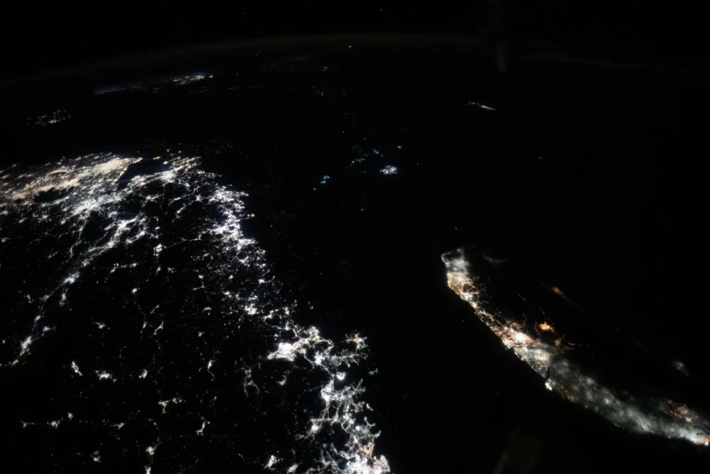 The Taiwan Strait at night from the International Space Station, with the city lights of China's coast on one side and Taiwan on the other